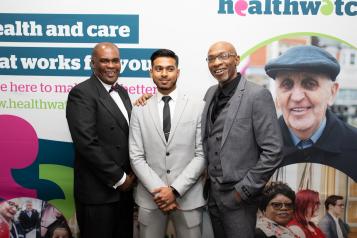 Group in front of Healthwatch posters