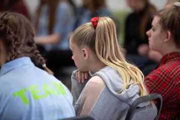 Young girl sat in a row of school children
