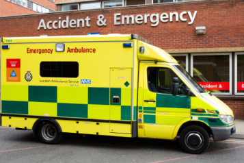 An ambulance parked outside a hospital A&E department