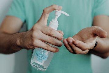 A person using hand sanitiser