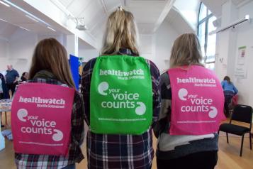 Healthwatch backpacks on three ladies backs