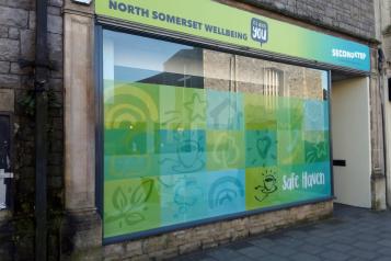 The outside of the Safe Haven shop front. Text on the sign reads: North Somerset Wellbeing and Second Step