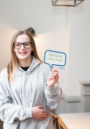Young girl holding a sign